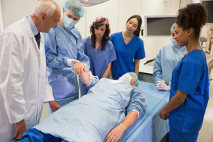 Medical students learning from professor.